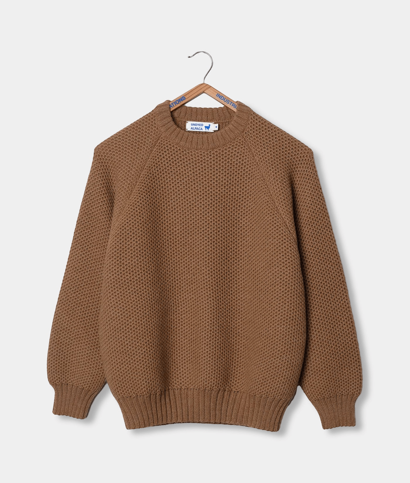 Brown textured knit sweater displayed on a hanger against a white background - Industry of All Nations