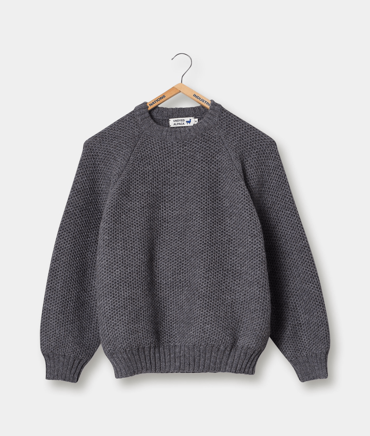 Grey alpaca sweater displayed on a hanger - Industry of All Nations