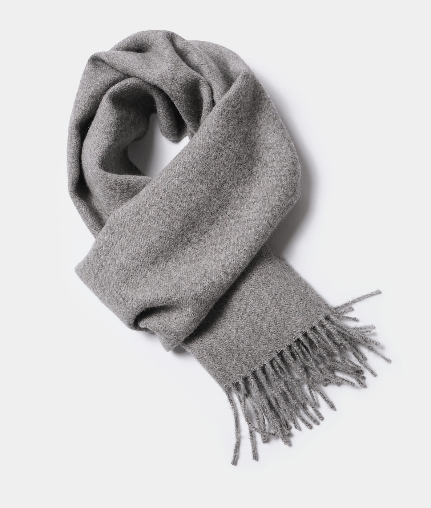 A gray wool scarf with fringed ends, displayed in a flat lay composition - Industry of All Nations