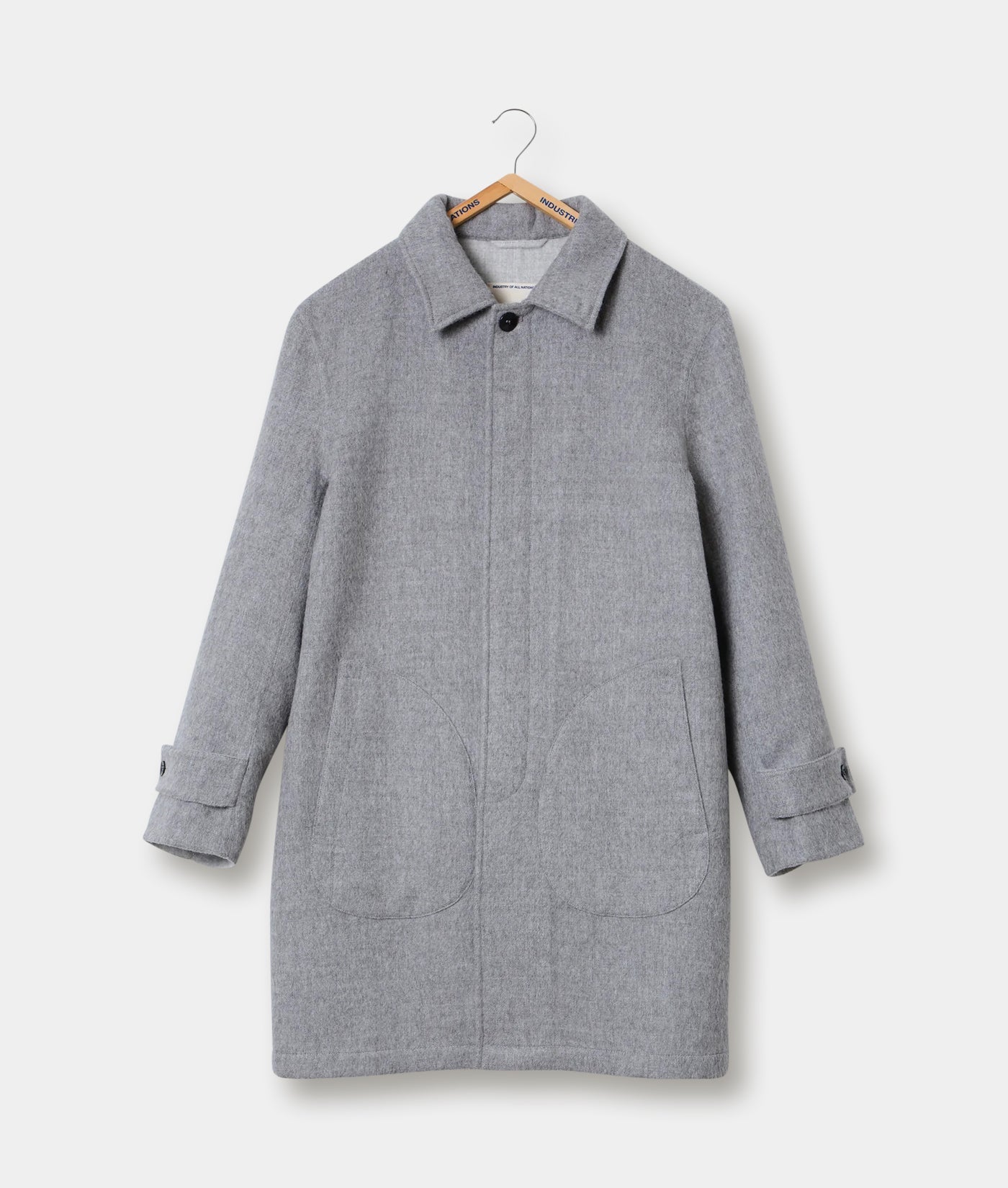 A gray wool coat hanging on a wooden hanger - Industry of All Nations