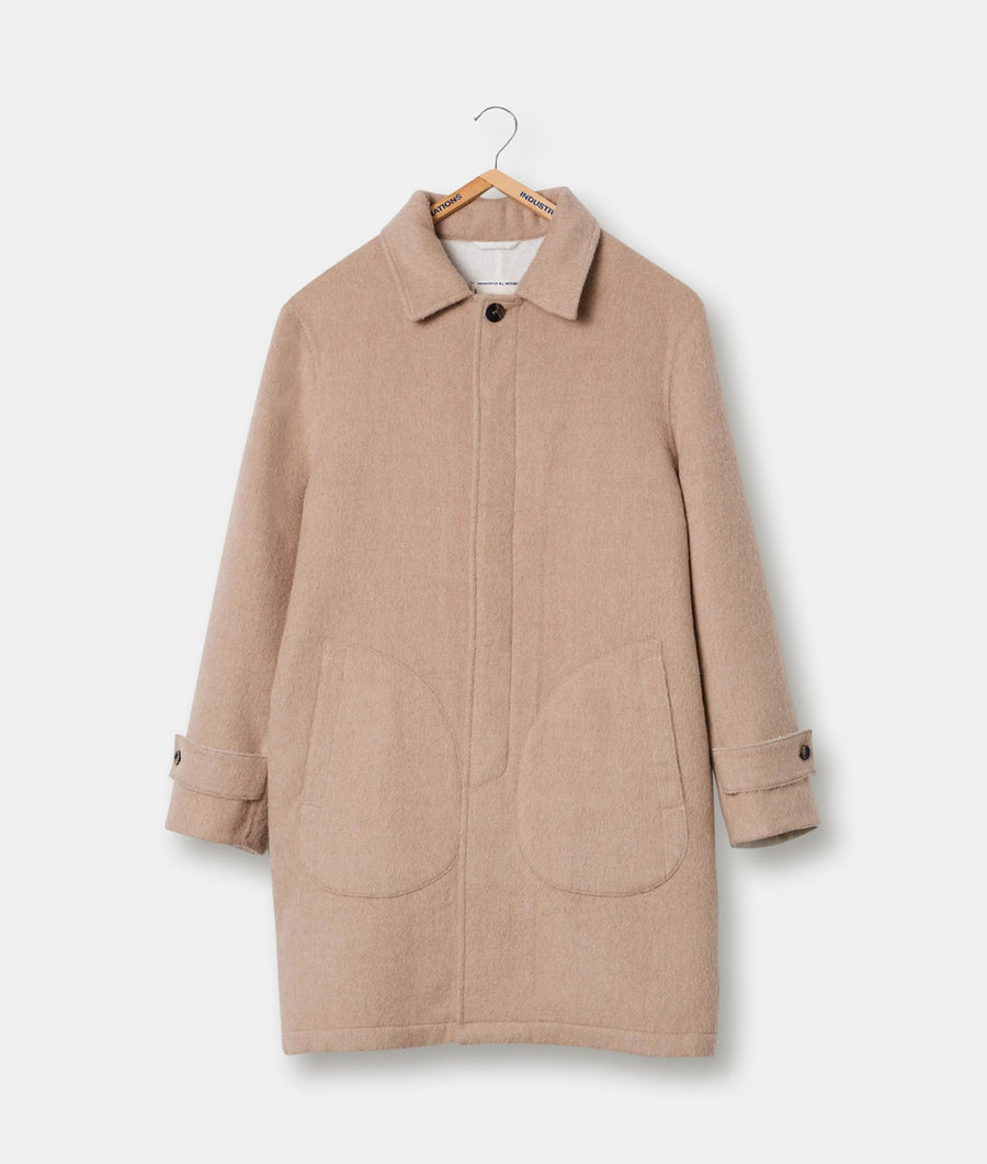 Tan-colored woolen coat hanging on a wooden hanger - Industry of All Nations