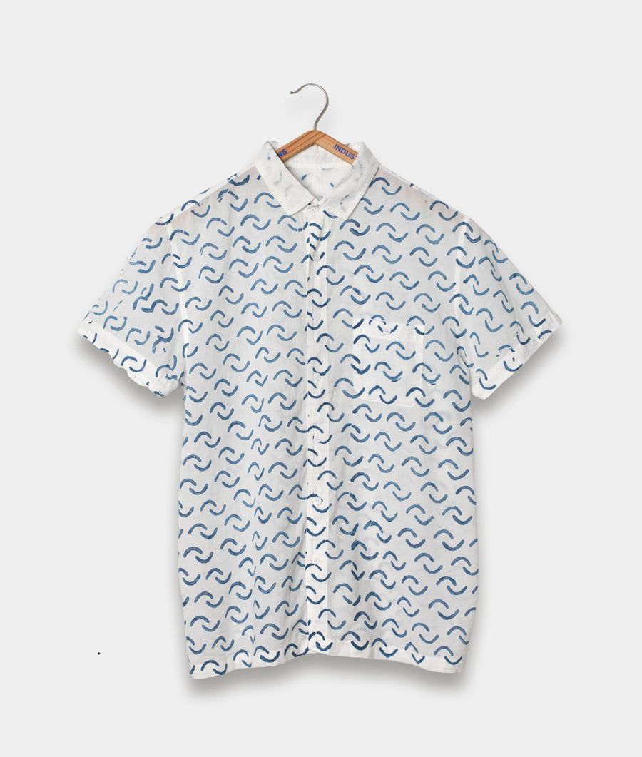 Shirt with blue wave pattern hanging on wooden hanger - Industry of All Nations