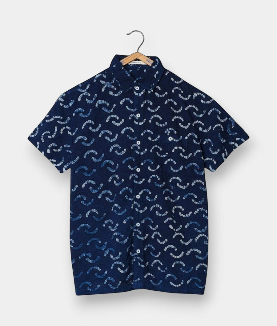 Navy blue button-down shirt with wavy print, displayed on a wooden hanger - Industry of All Nations