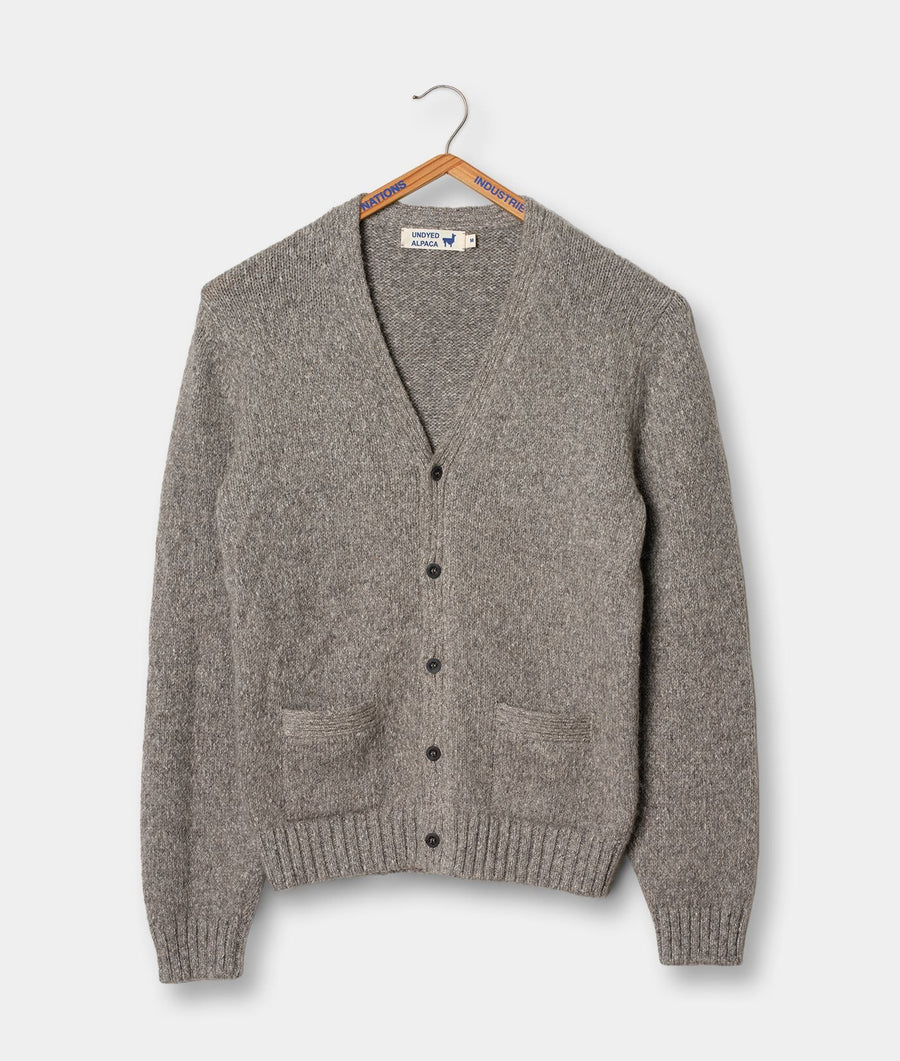 Grey knitted cardigan sweater displayed on a hanger - Industry of All Nations