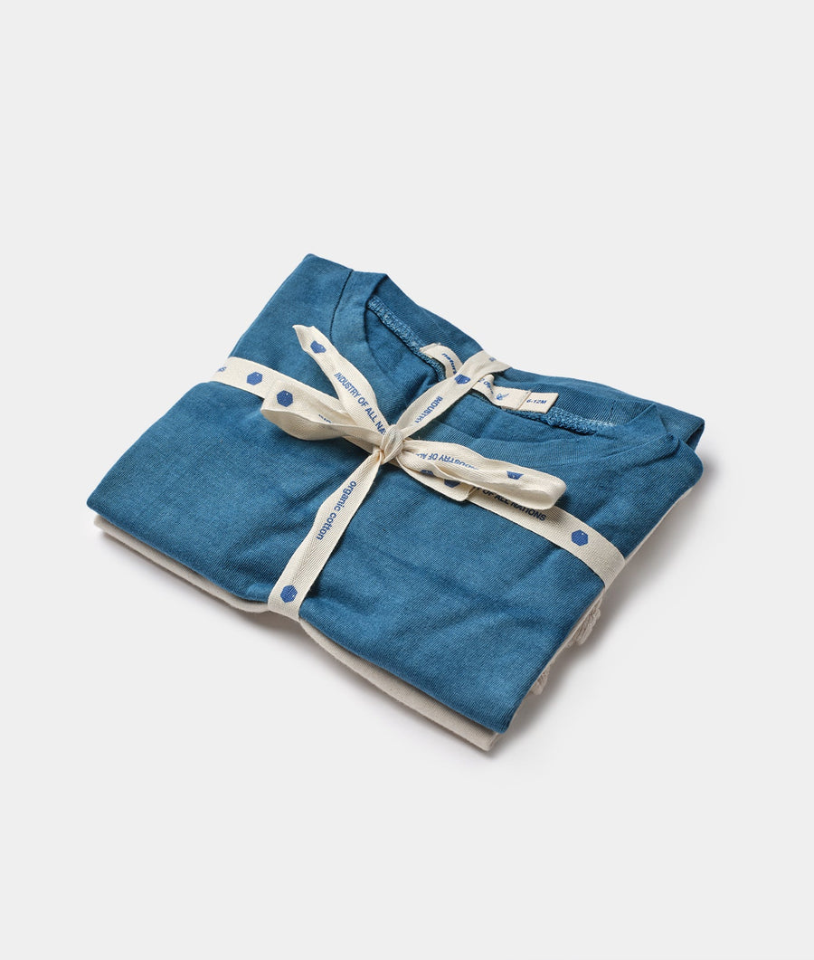 Folded blue organic cotton t-shirt with white dots, tied with a beige ribbon - Industry of All Nations
