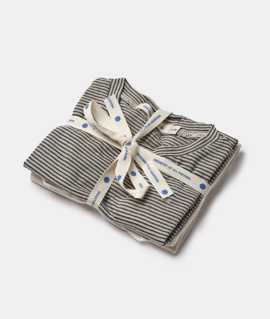 Flat lay of striped organic cotton tea towels wrapped in a cream ribbon with blue polka dots - Industry of All Nations