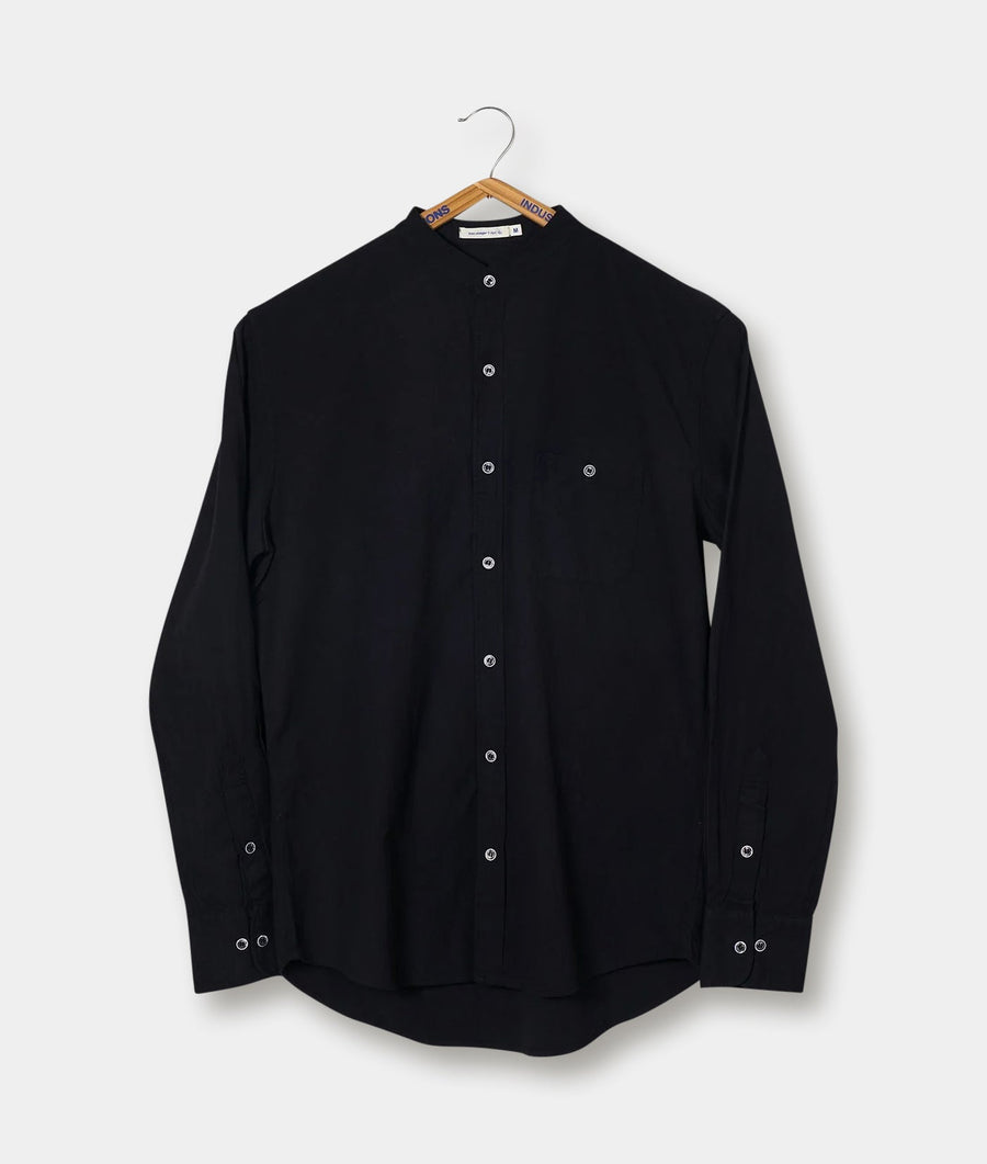 Black button-up shirt hanging on a clothing rack - Industry of All Nations