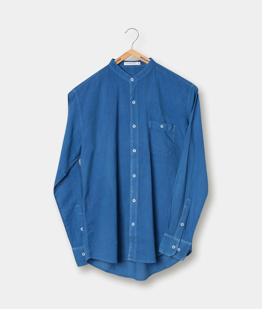 A blue collared button-down shirt hanging on a wooden clothes hanger - Industry of All Nations