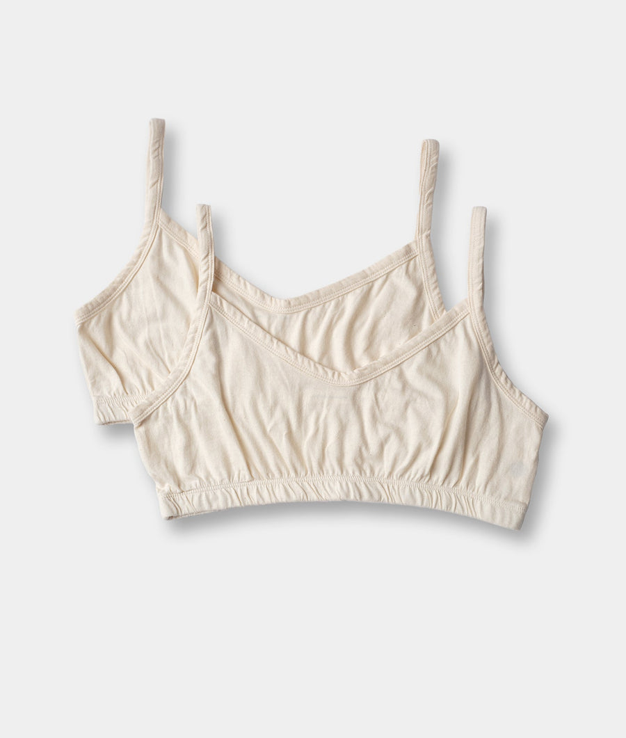 Pair of beige organic cotton sports bras displayed in a flat lay arrangement against a white background - Industry of All Nations