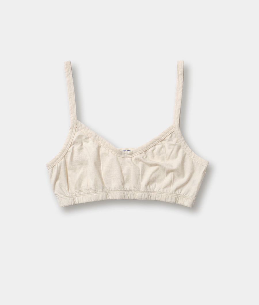 Cream-colored organic cotton crop top in a flat lay display - Industry of All Nations