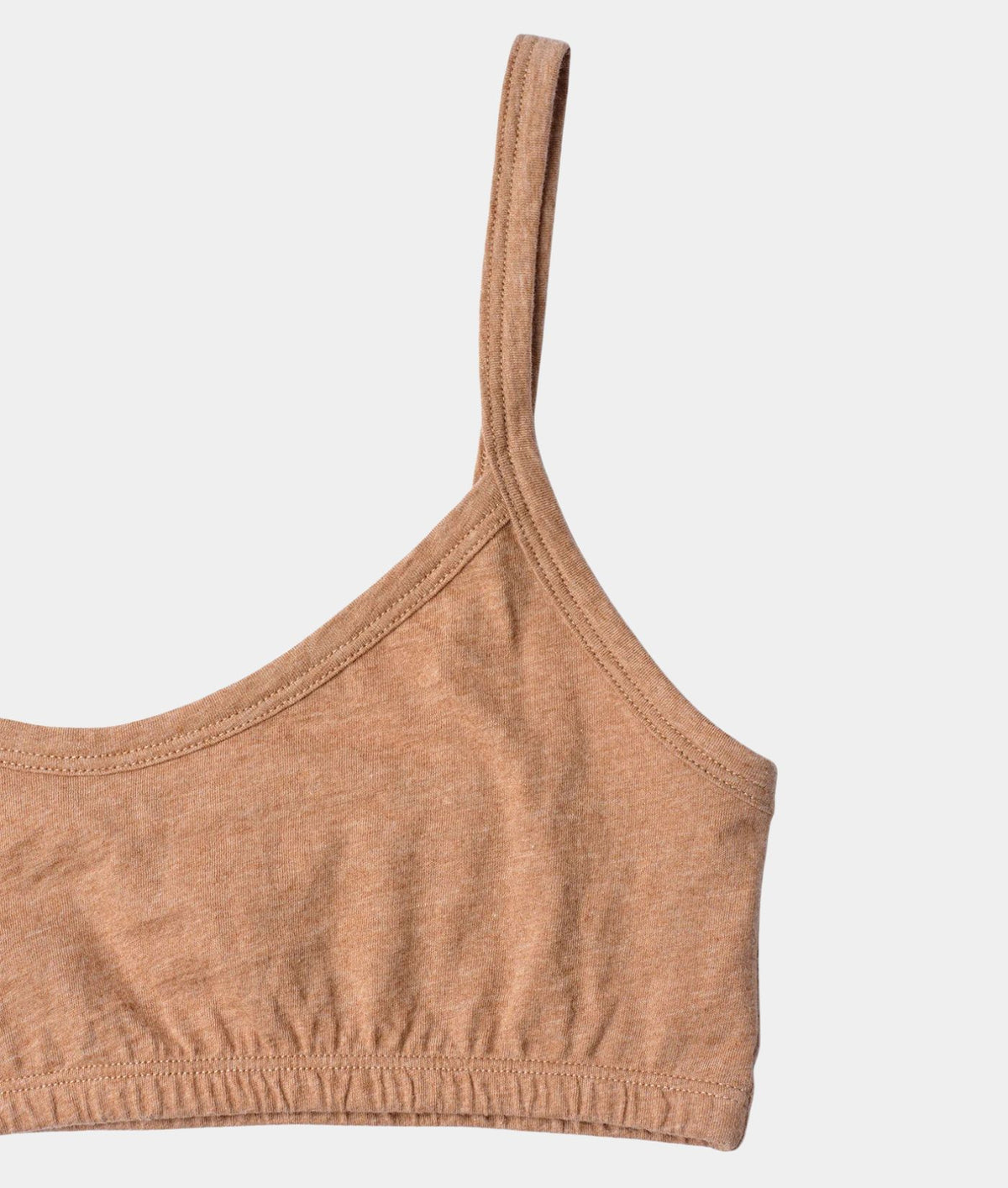 Close-up of a heathered tan ribbed knit bralette or sports bra strap and cup on a light gray background.