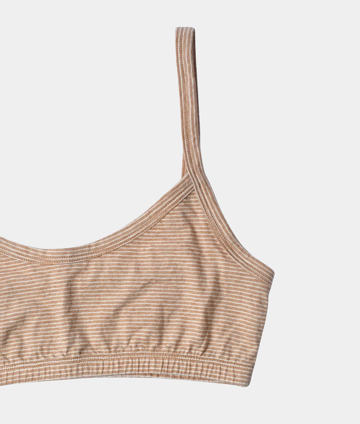 Close-up of a ribbed knit camisole crop top with thin shoulder straps, featuring a fine horizontal stripe pattern in beige and brown on a light gray background.