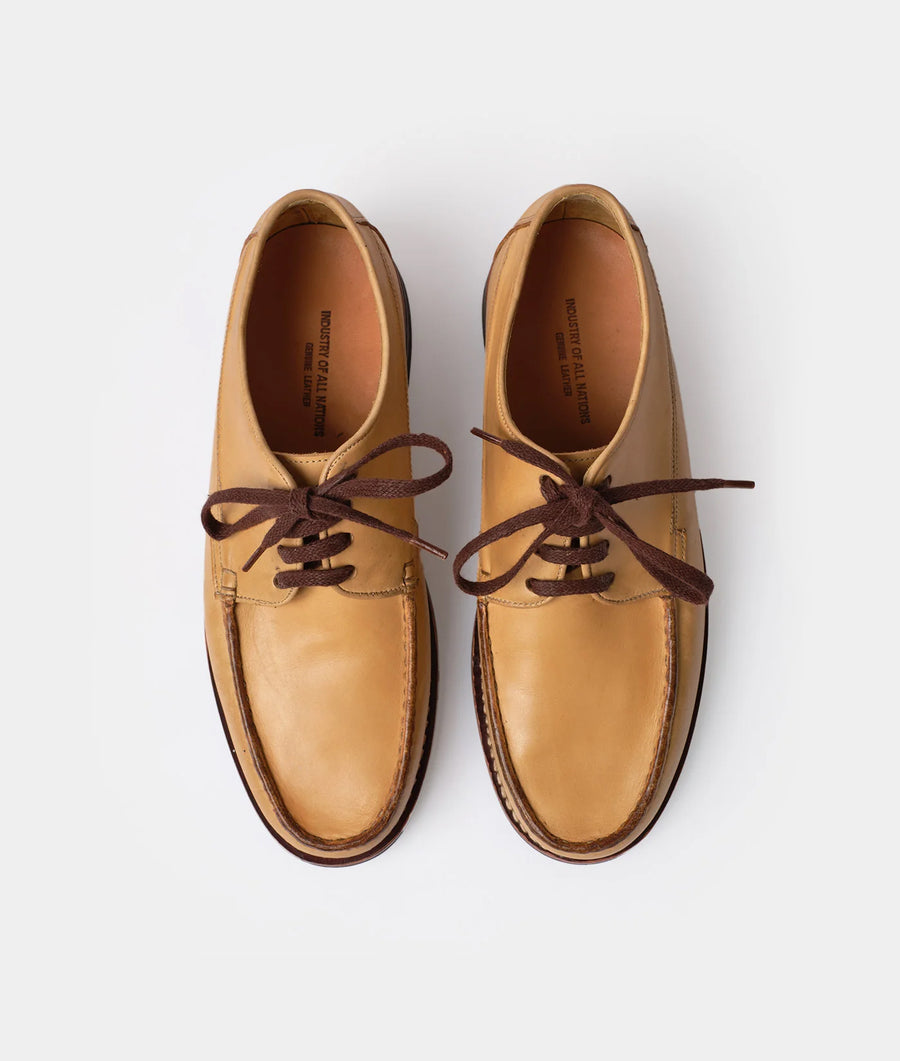 Pair of tan leather lace-up shoes displayed on a white background - Industry of All Nations