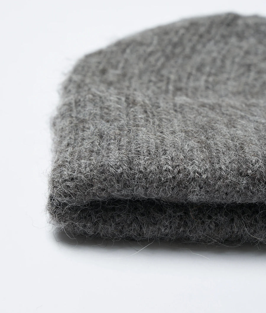 Closeup detail shot of a grey woolen fabric swatch - Industry of All Nations