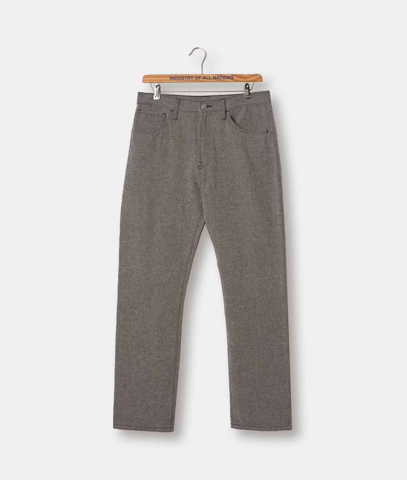 Gray cotton pants displayed on a hanger with the brand name "Industry of All Nations" visible on the hanger - Industry of All Nations
