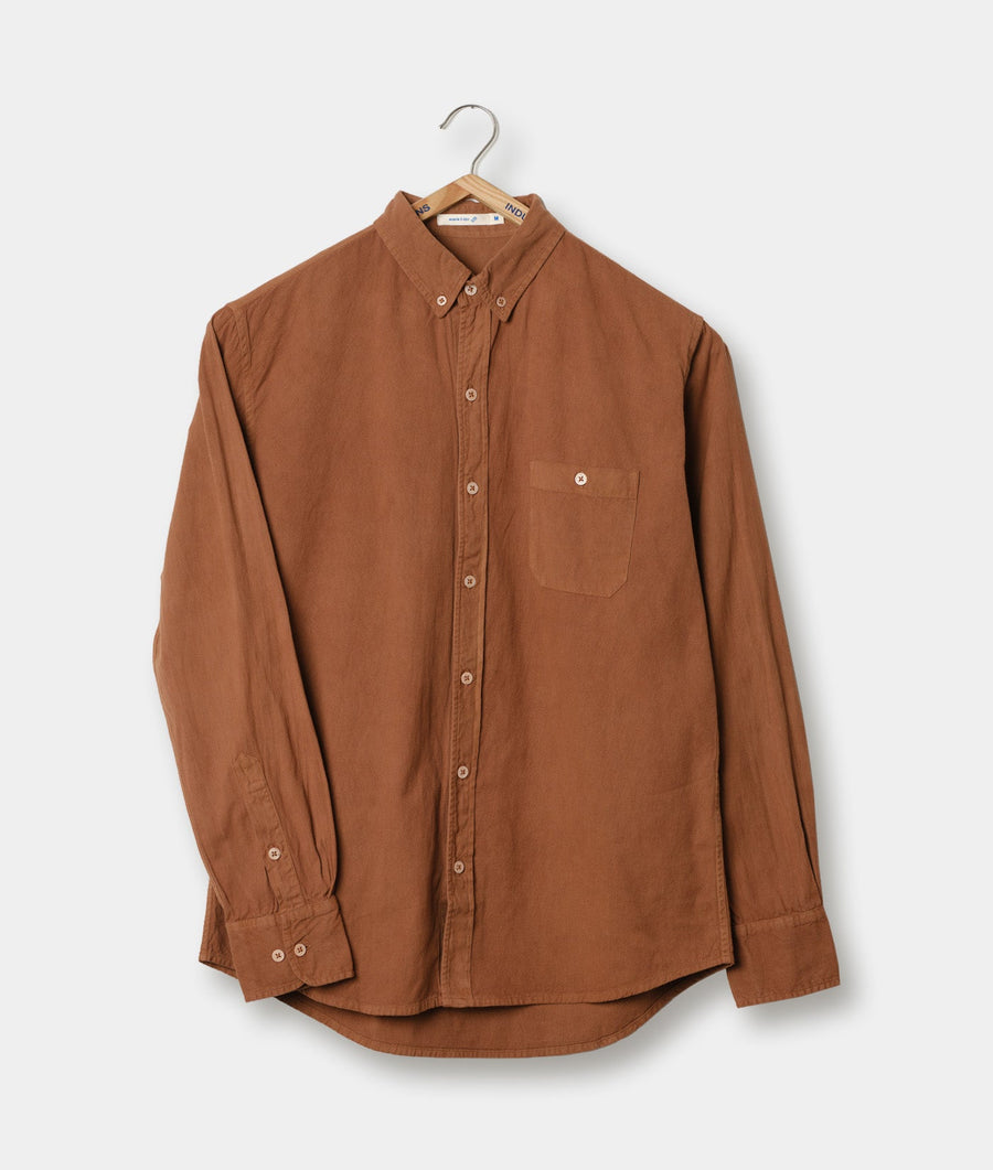 Brown cotton button-down shirt hung on a hanger against a white background - Industry of All Nations