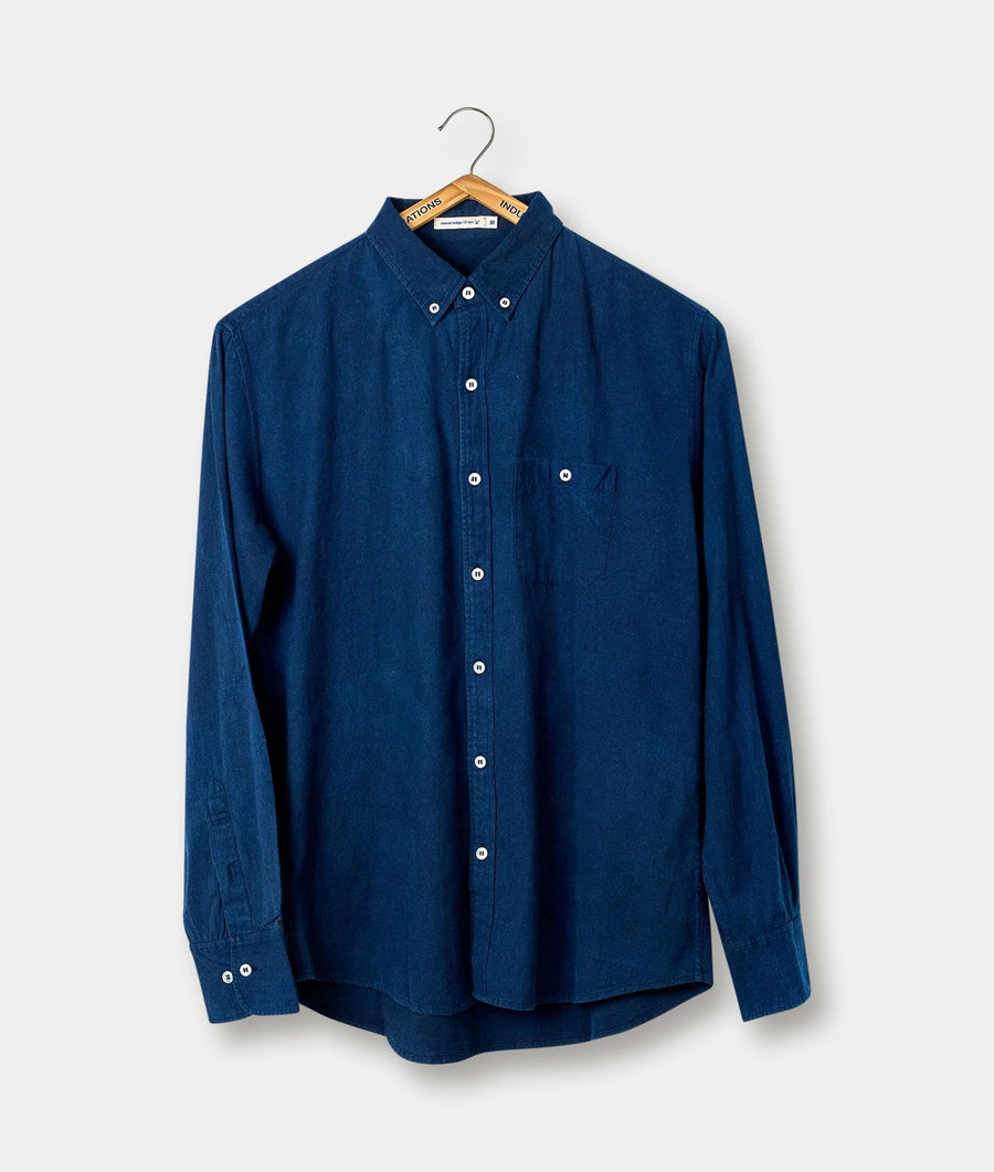 Navy blue button-down shirt hanging on a wooden hanger - Industry of All Nations