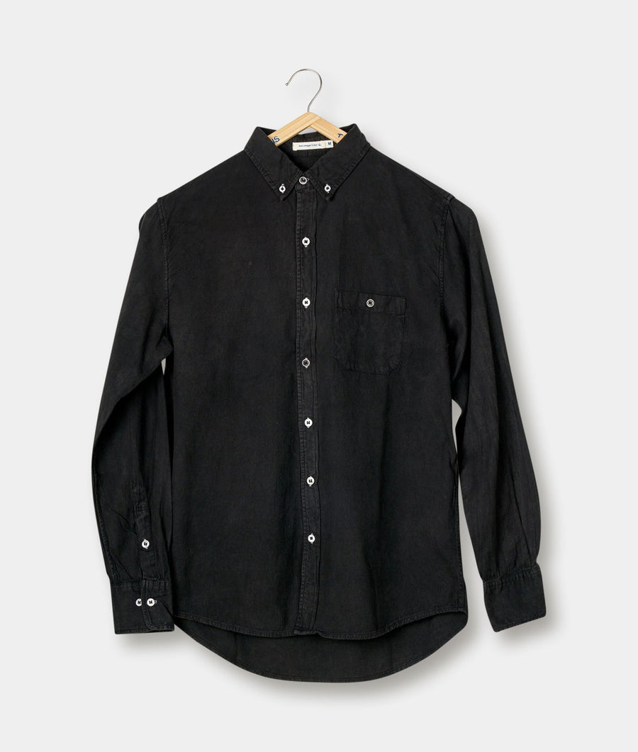 A black button-down shirt displayed on a hanger - Industry of All Nations