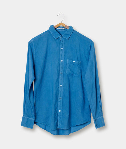 Blue button-down shirt hanging on a hanger - Industry of All Nations
