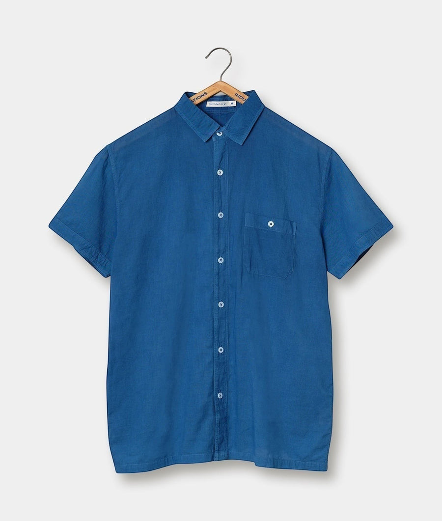 A blue button-down short-sleeve shirt displayed on a wooden hanger - Industry of All Nations