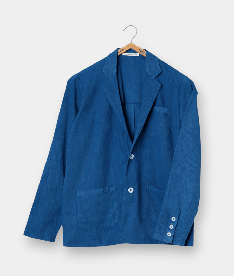 Blue cotton jacket displayed on a hanger - Industry of All Nations