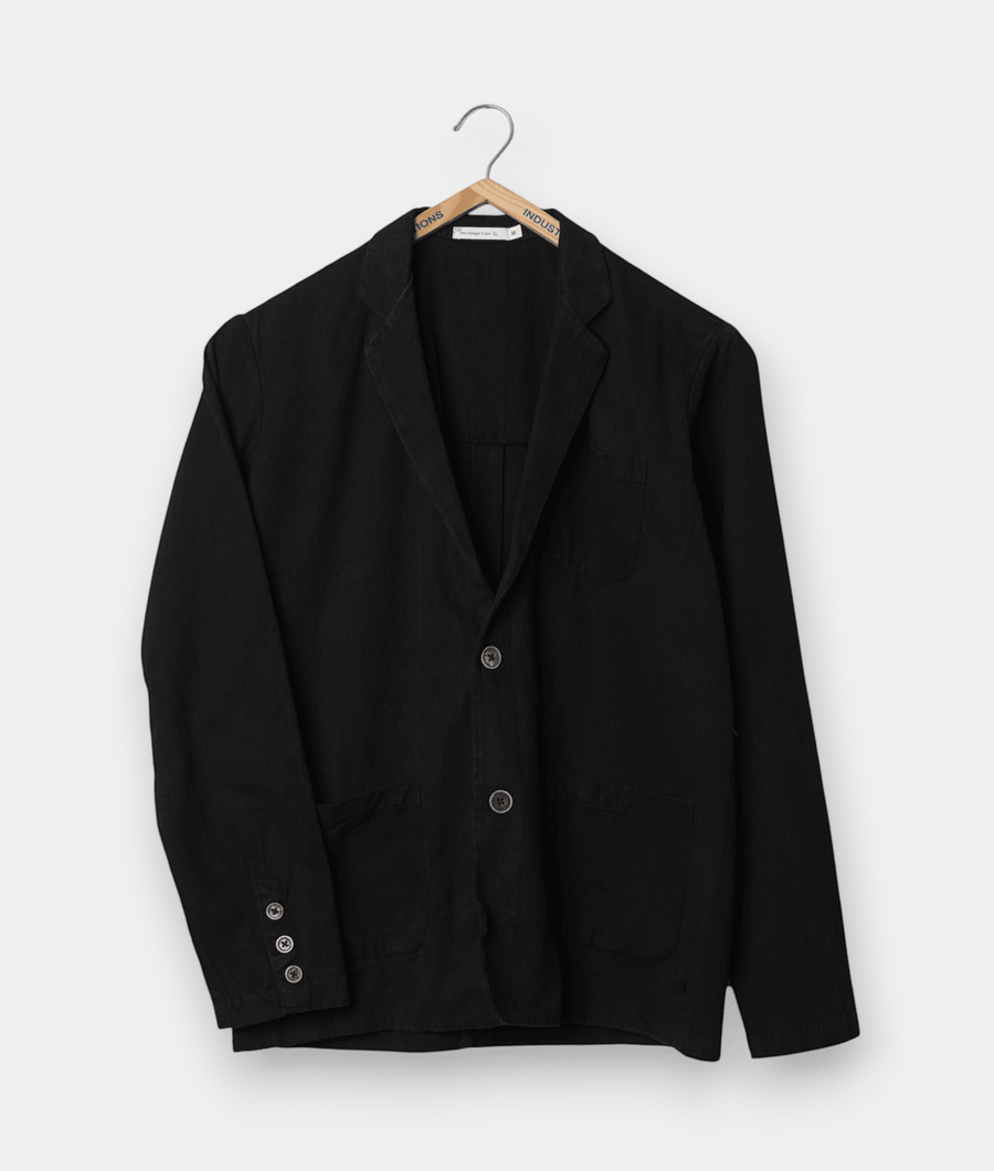A black wool suit jacket hanging on a wooden hanger - Industry of All Nations