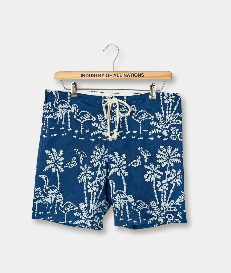 Pair of navy blue and white printed shorts displayed on a wooden hanger with the brand name "Industry of All Nations" printed on it - Industry of All Nations