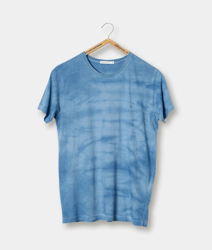 A blue tie-dyed t-shirt displayed on a hanger - Industry of All Nations