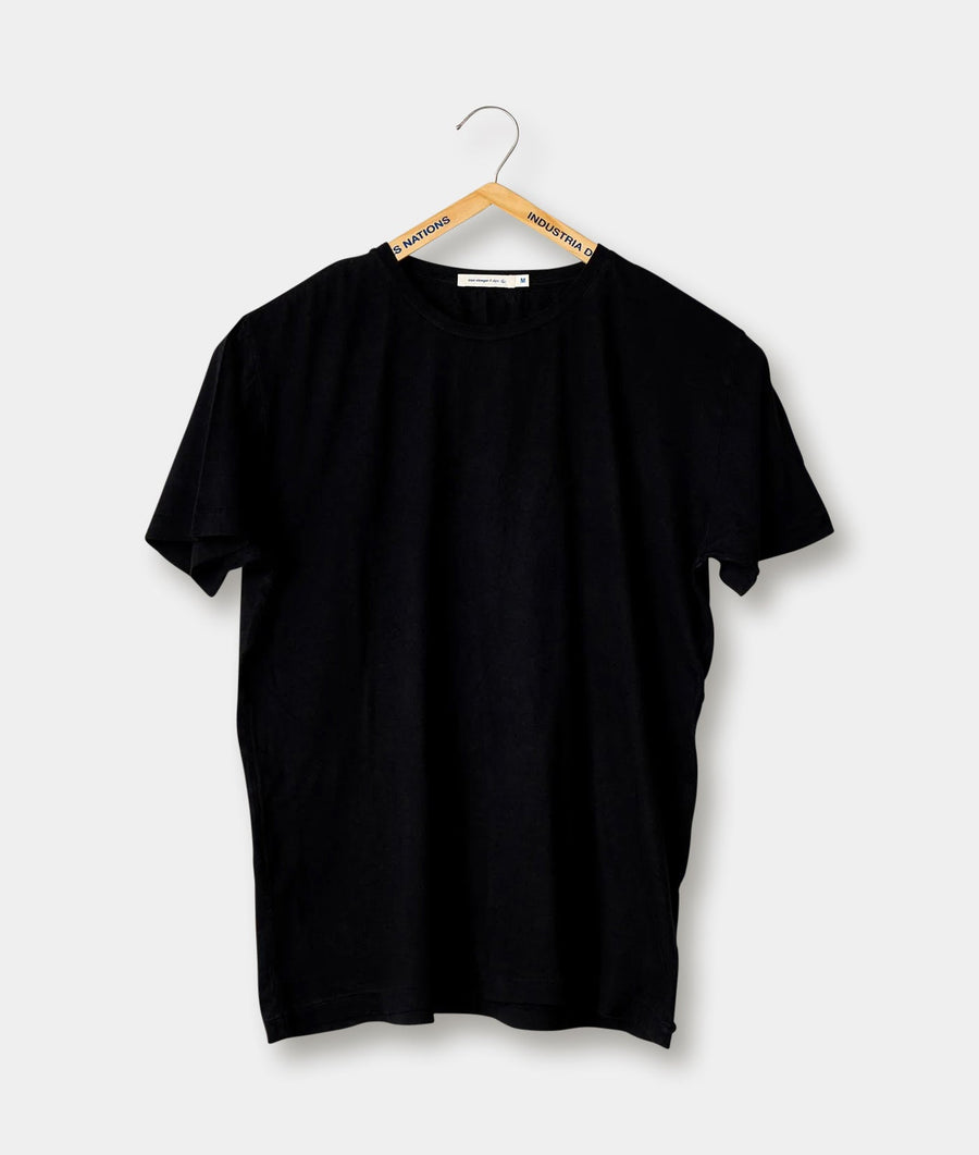 Black t-shirt hanging on a wooden hanger with the brand name "Industry of All Nations" visible - Industry of All Nations