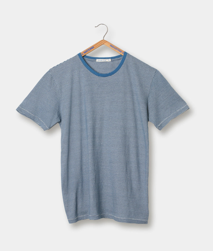 A blue and white striped t-shirt, displayed on a wooden hanger - Industry of All Nations