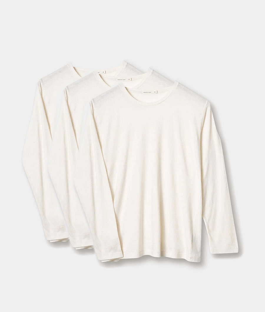Three white long-sleeve organic cotton t-shirts displayed in a flat lay arrangement - Industry of All Nations