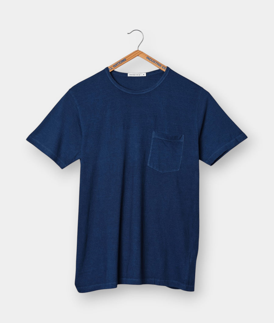 Navy blue t-shirt with front pocket displayed on a hanger - Industry of All Nations