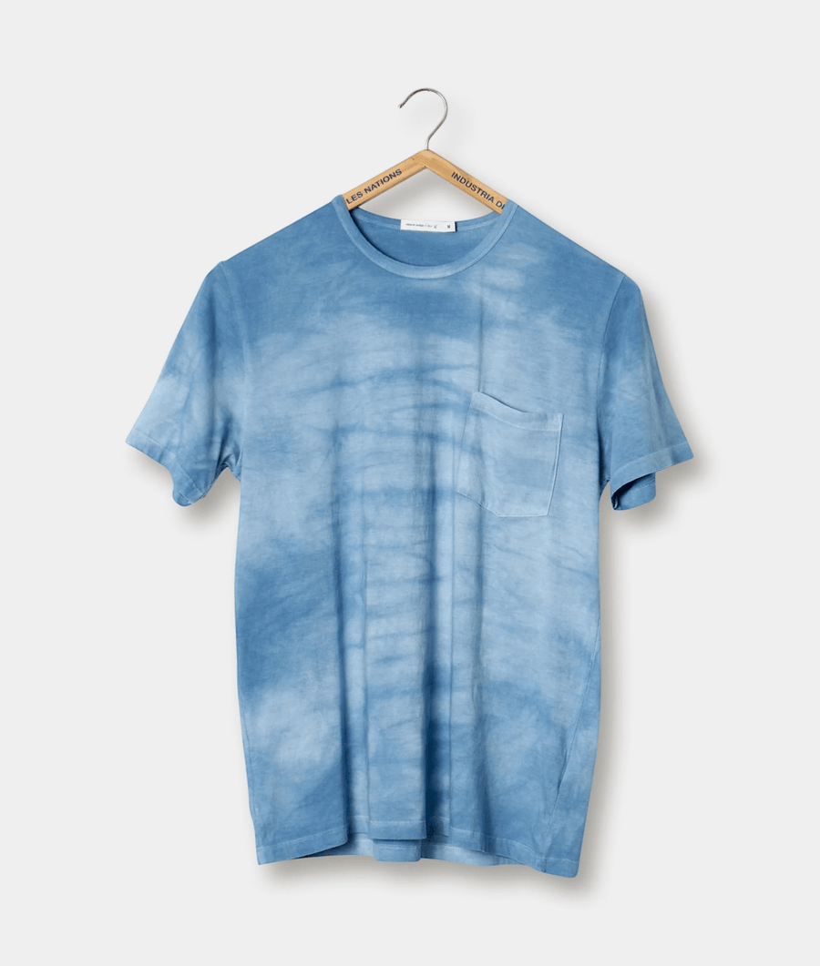 Light blue tie-dye t-shirt with chest pocket hanging on hanger - Industry of All Nations