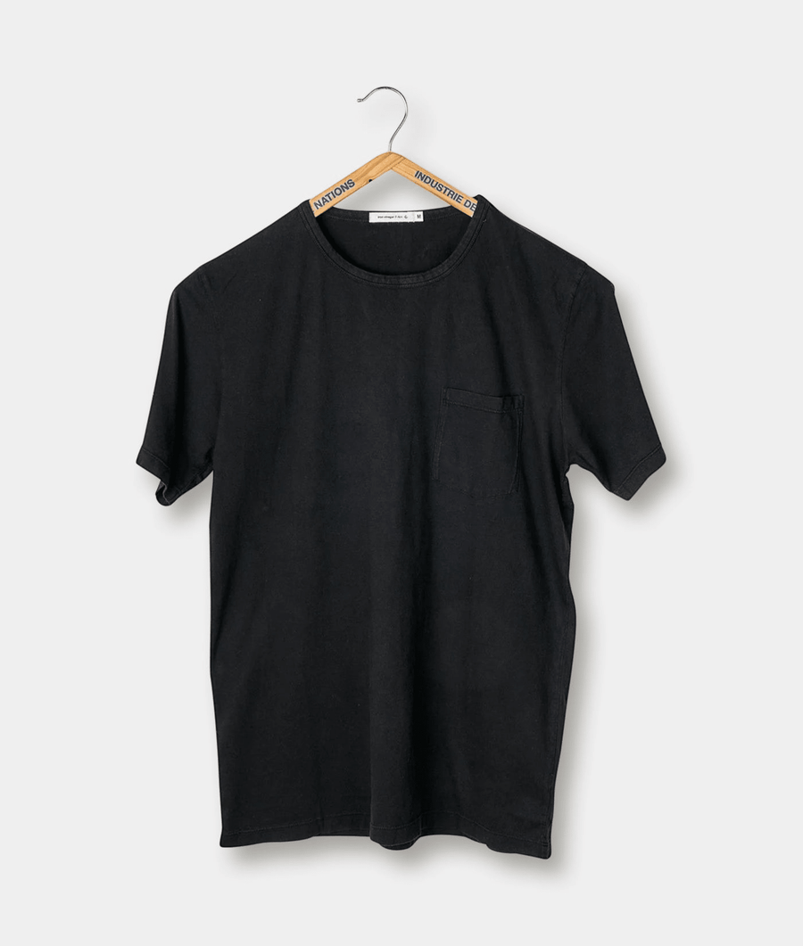 Black t-shirt with front pocket displayed on a hanger - Industry of All Nations
