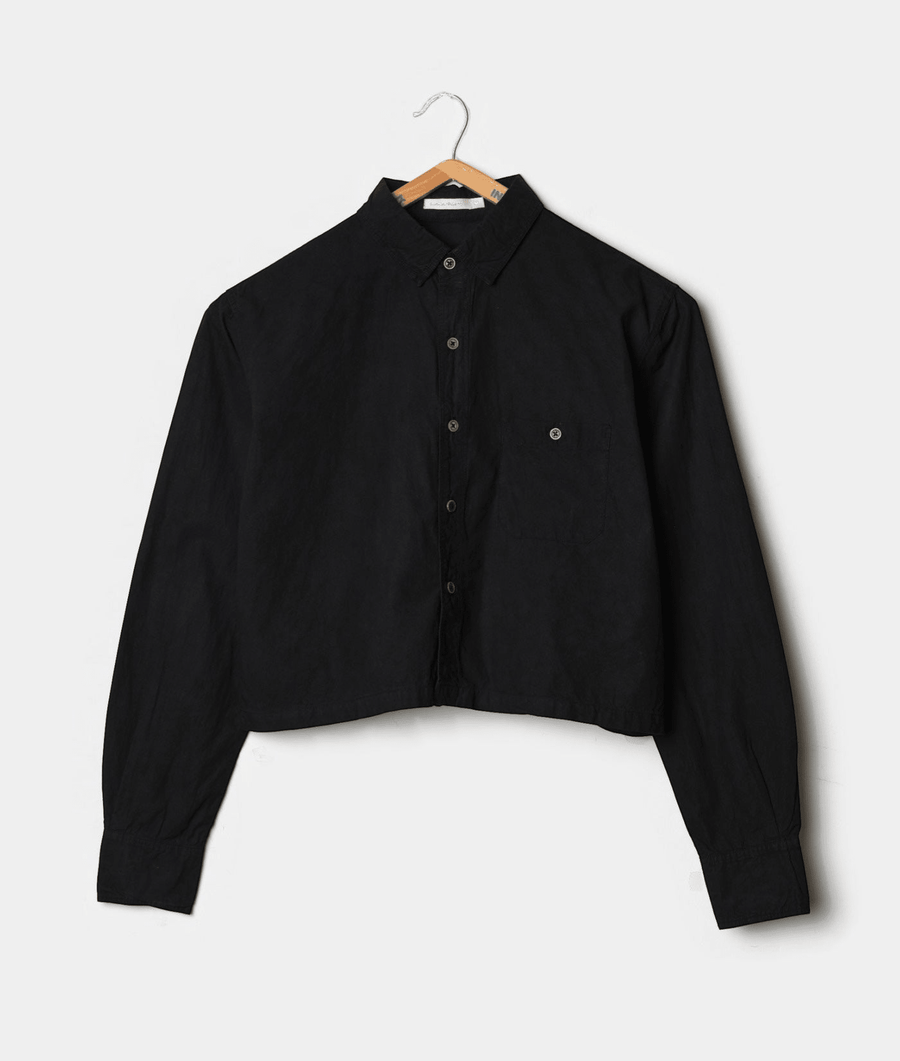 A black button-down shirt displayed on a wooden hanger against a white background - Industry of All Nations
