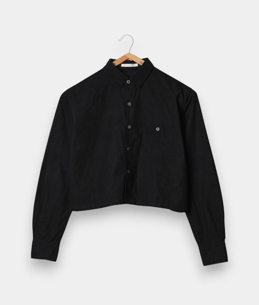 A black button-down shirt displayed on a wooden hanger against a white background - Industry of All Nations