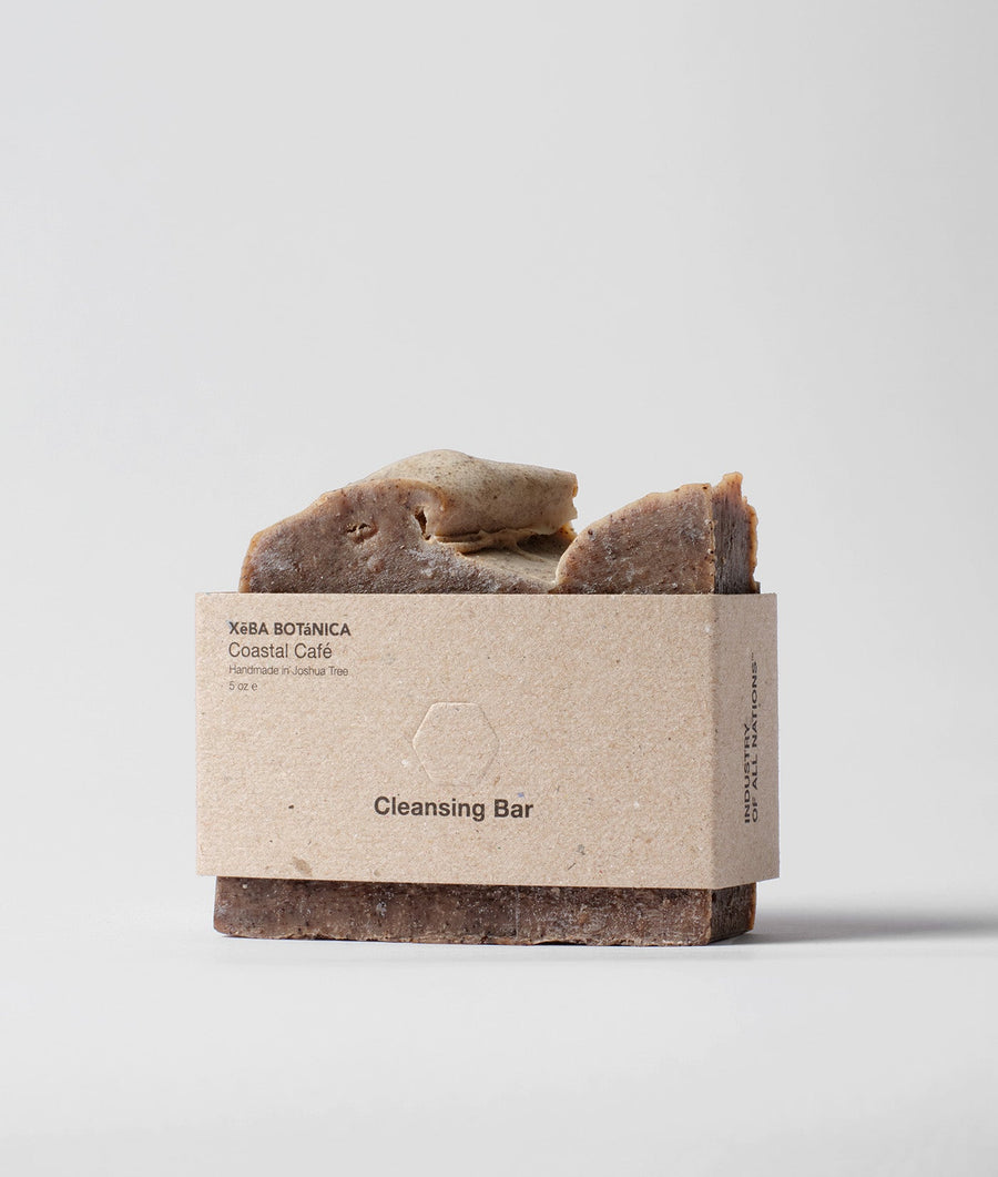 A rectangular brown bar of Coastal Café handmade cleansing soap on a plain background with simple packaging - Industry of All Nations