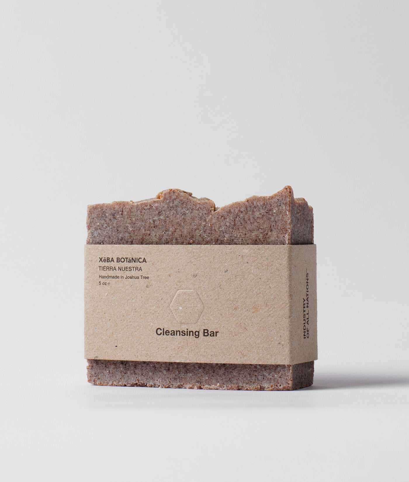 A rectangular brown cleansing bar with a simple paper label that says "Cleansing Bar" - Industry of All Nations