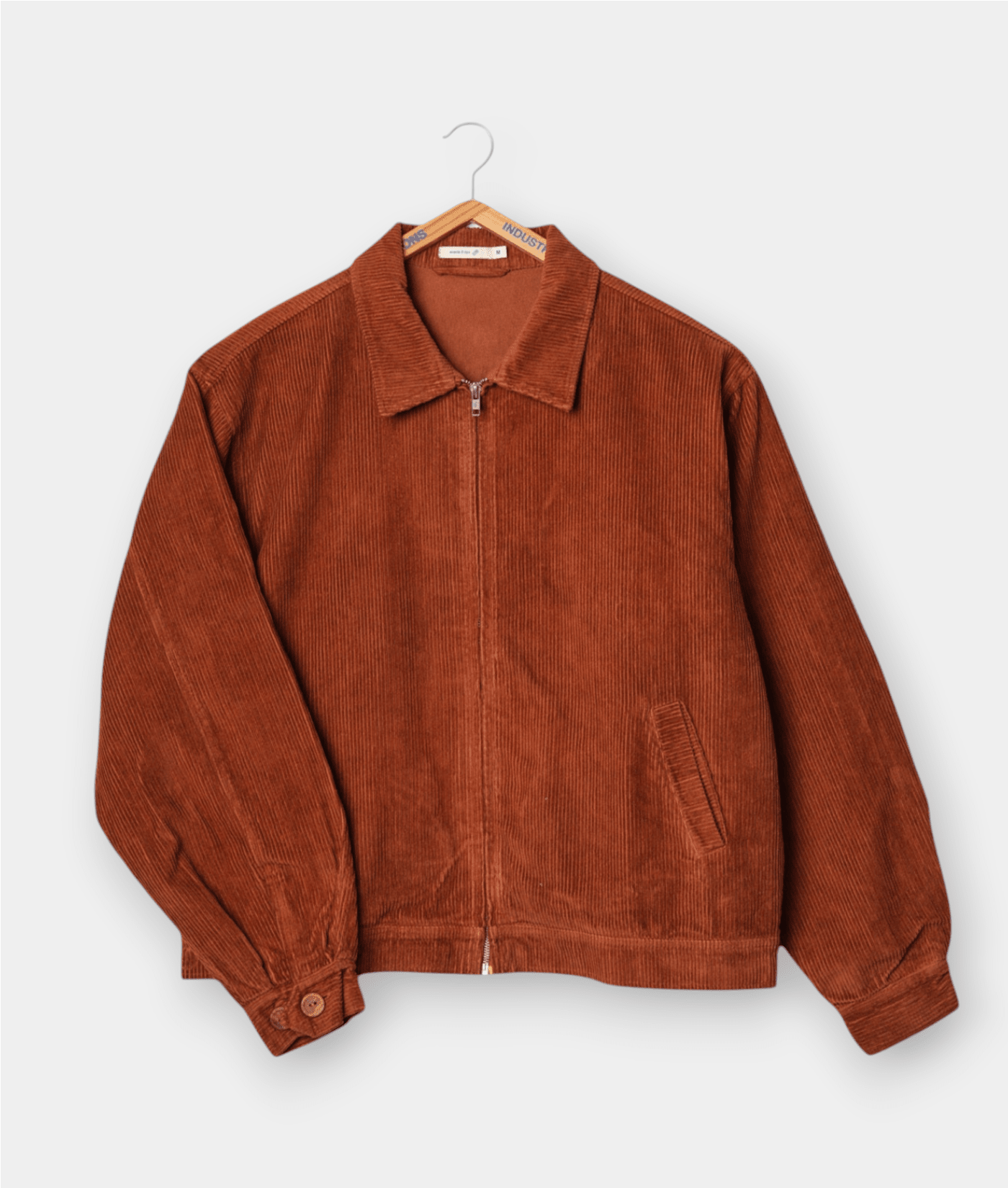 A burnt orange corduroy jacket, displayed flat on a white background - Industry of All Nations