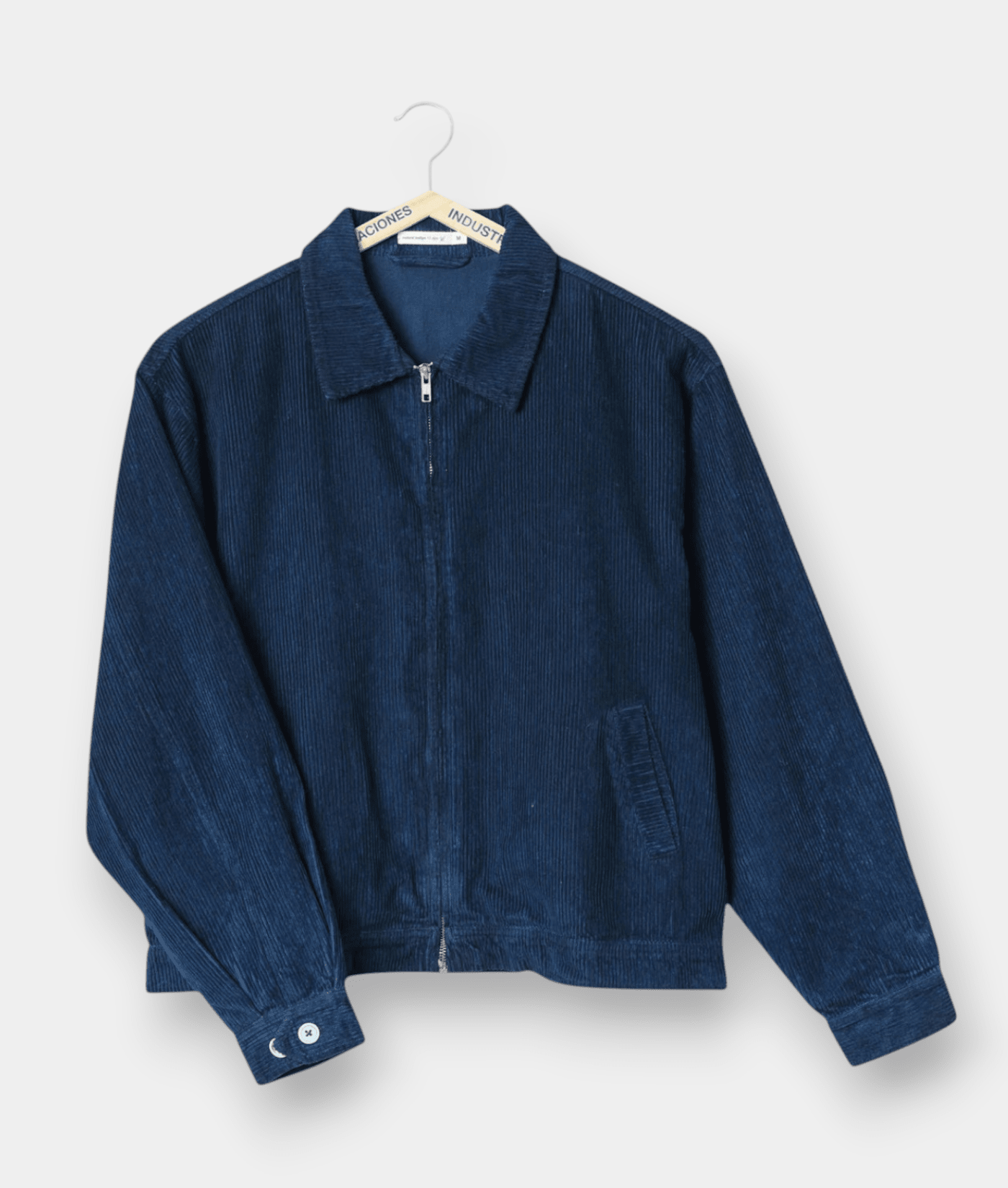 Dark blue corduroy zip-up jacket displayed on a hanger - Industry of All Nations