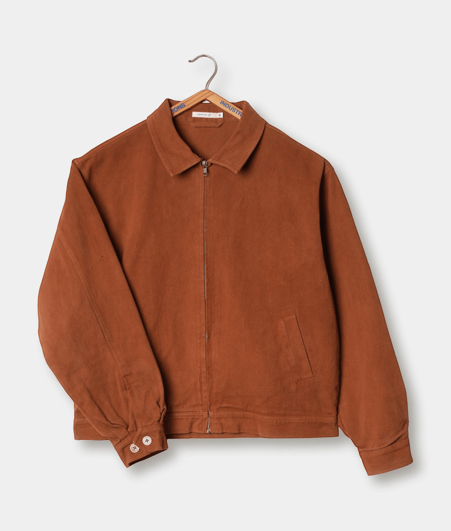 A brown zip-up jacket displayed on a hanger - Industry of All Nations