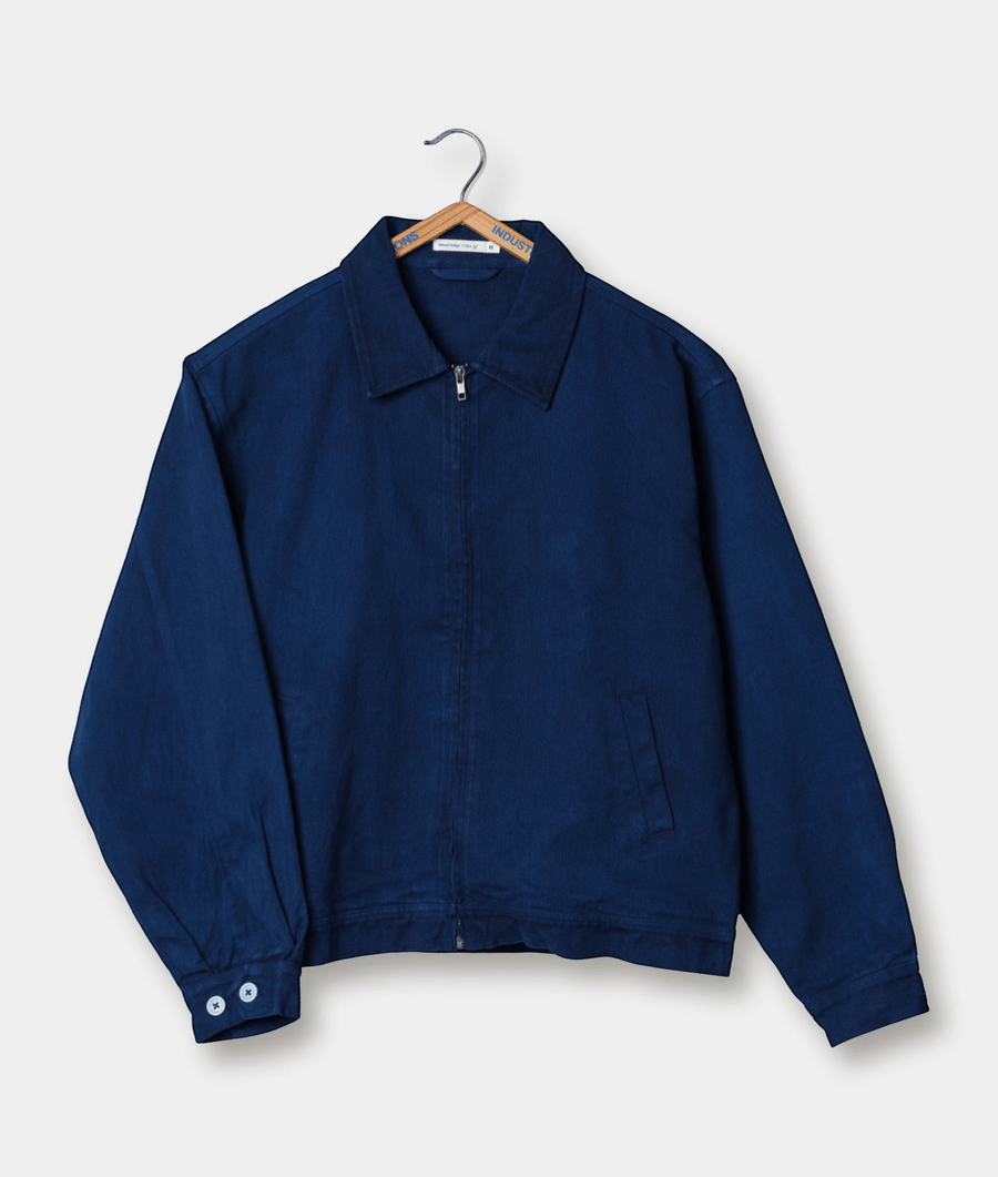 Navy blue zip-up jacket, hanging on a wooden hanger against a plain background - Industry of All Nations