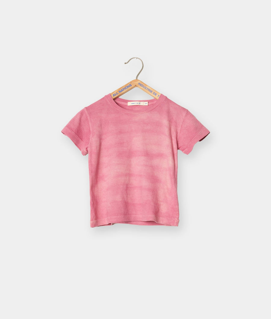 Pink organic cotton t-shirt hanging on wooden hanger with brand tag - Industry of All Nations