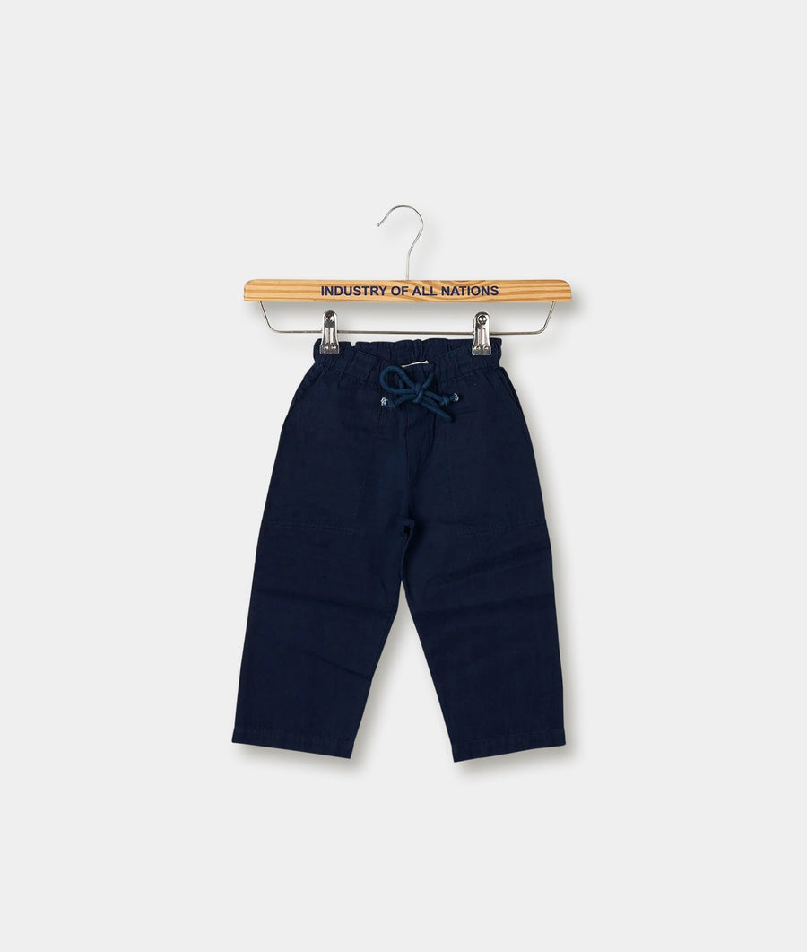 Navy blue cotton drawstring pants displayed on a wooden hanger with "Industry of All Nations" printed on it - Industry of All Nations