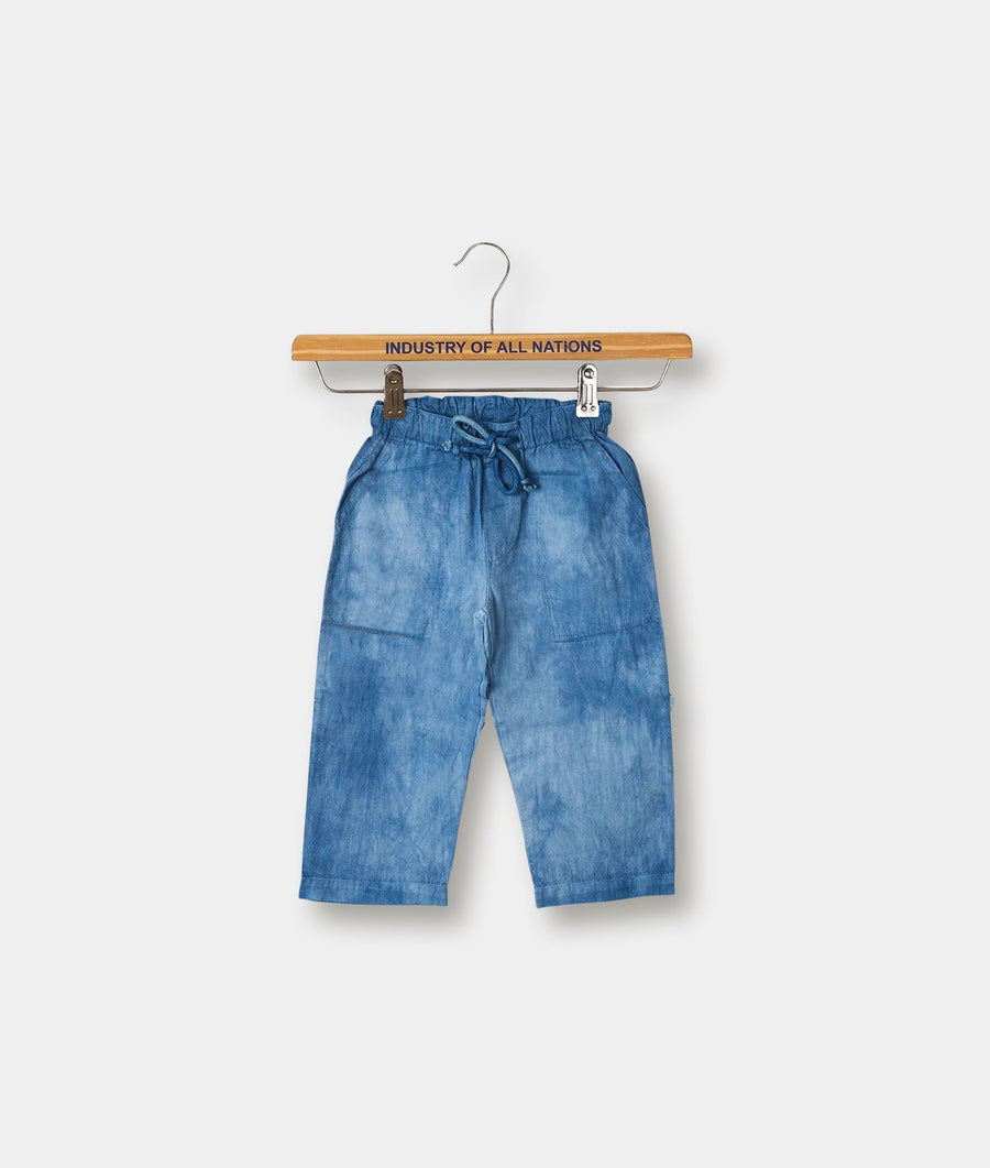 Blue denim casual pants with drawstring waist, hanging on a wooden clothing hanger labeled "Industry of All Nations" - Industry of All Nations