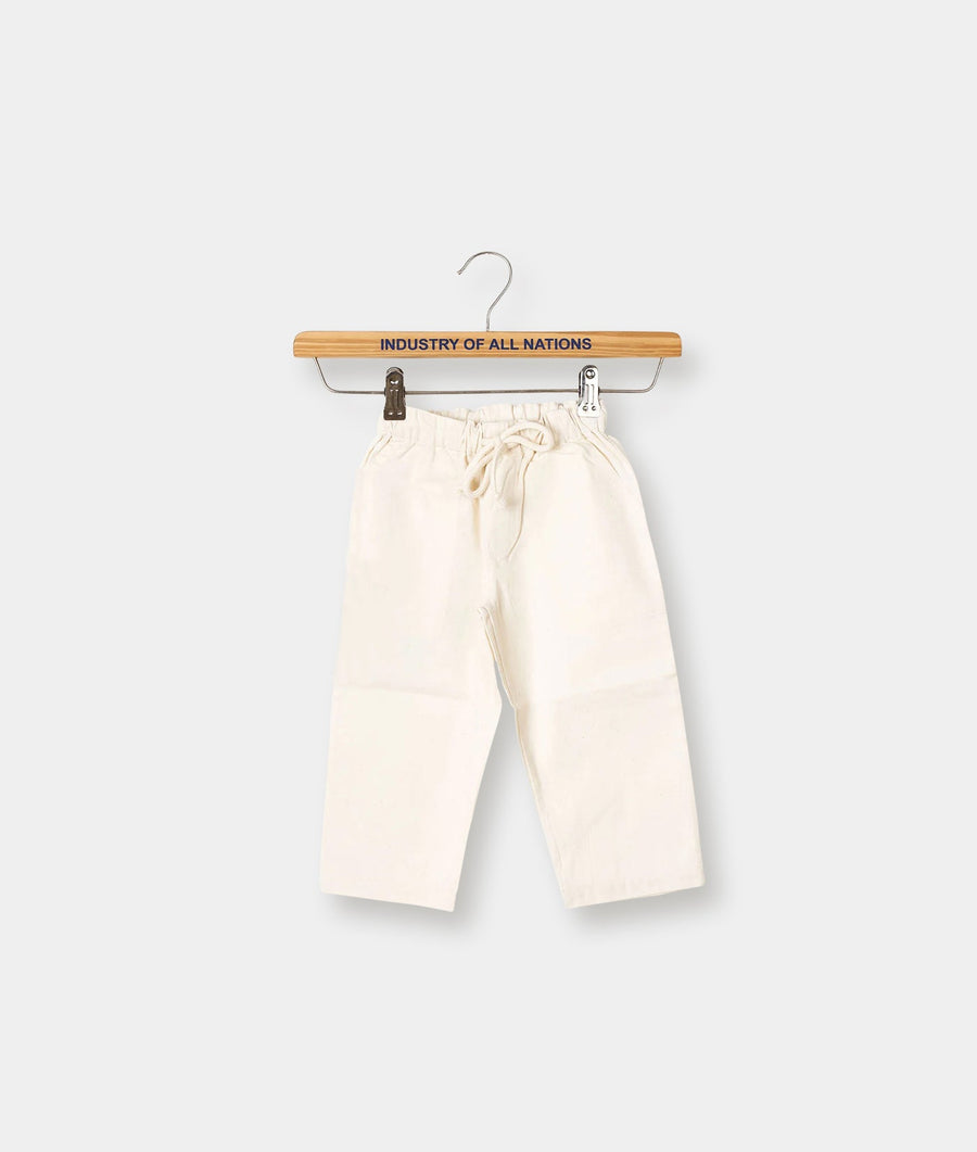 Cream-colored organic cotton drawstring pants hanging on an "Industry of All Nations" branded wooden hanger - Industry of All Nations