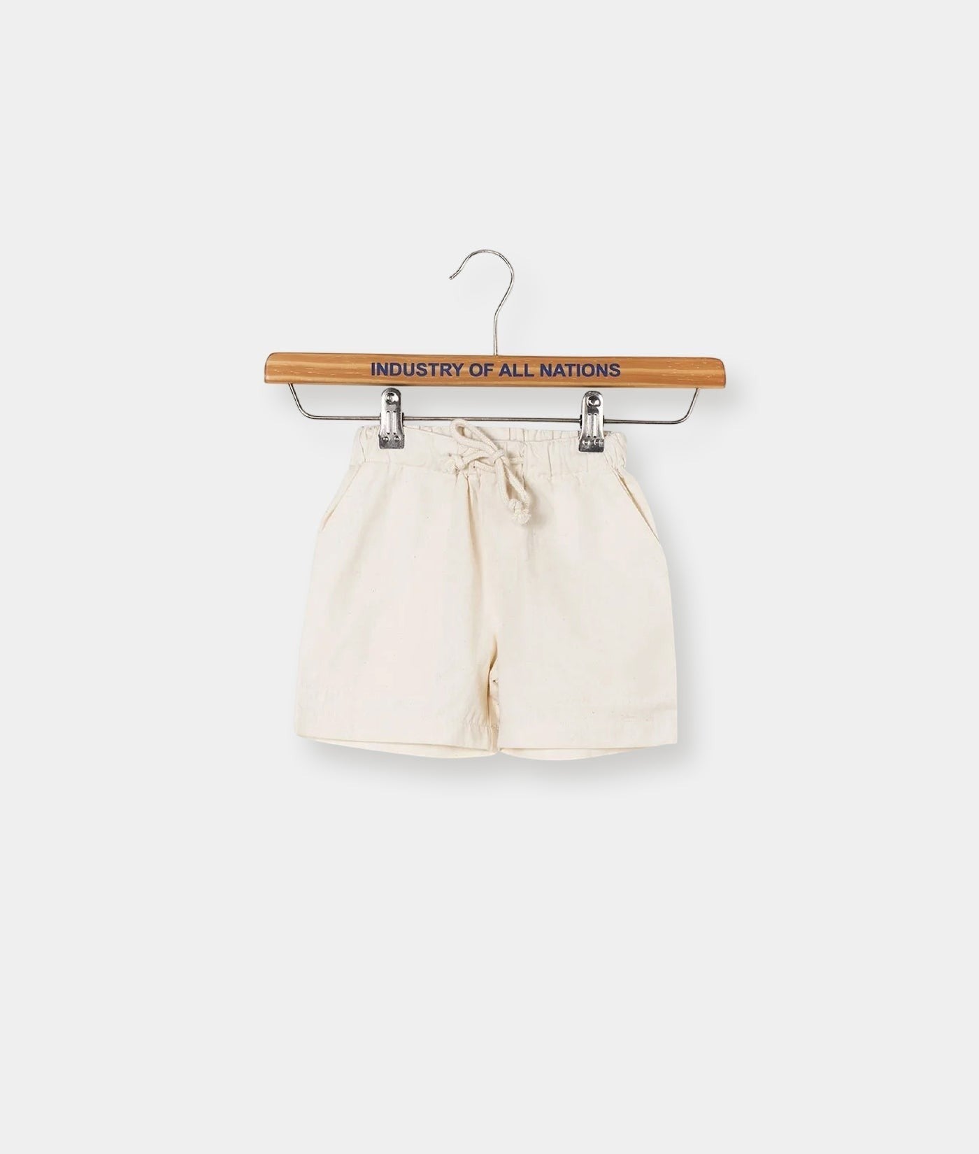 White cotton shorts displayed on a wooden hanger with the text "Industry of All Nations" - Industry of All Nations