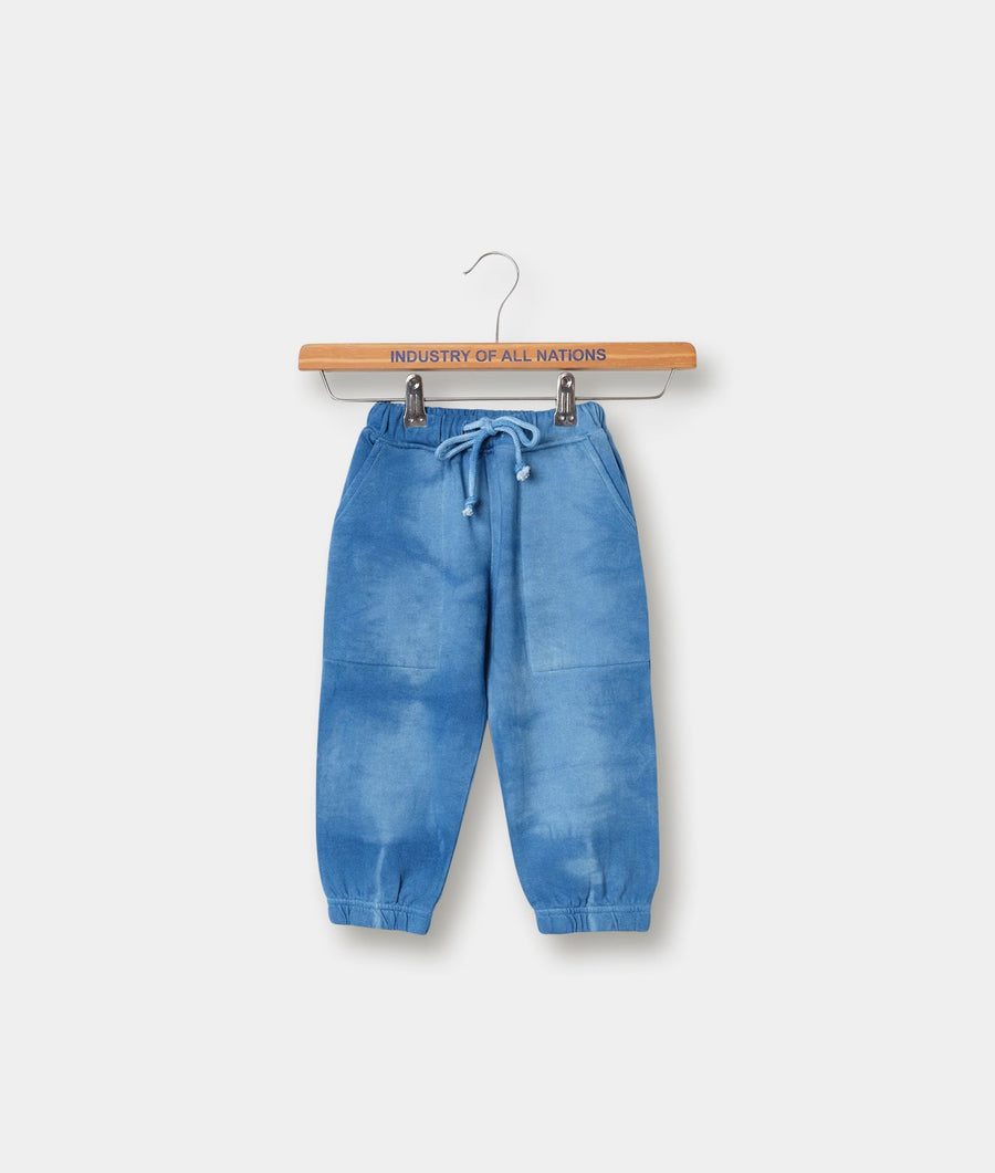 Blue denim drawstring pants displayed on a wooden hanger with "Industry of All Nations" text - Industry of All Nations