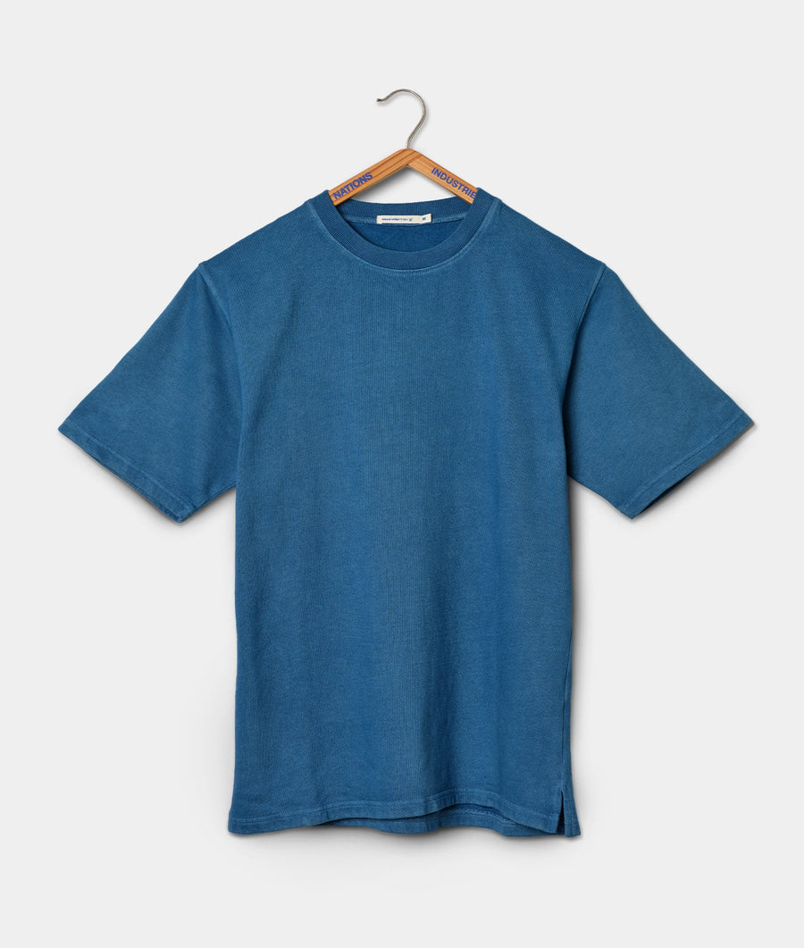 A blue tee shirt hanging on a wooden hanger - Industry of All Nations
