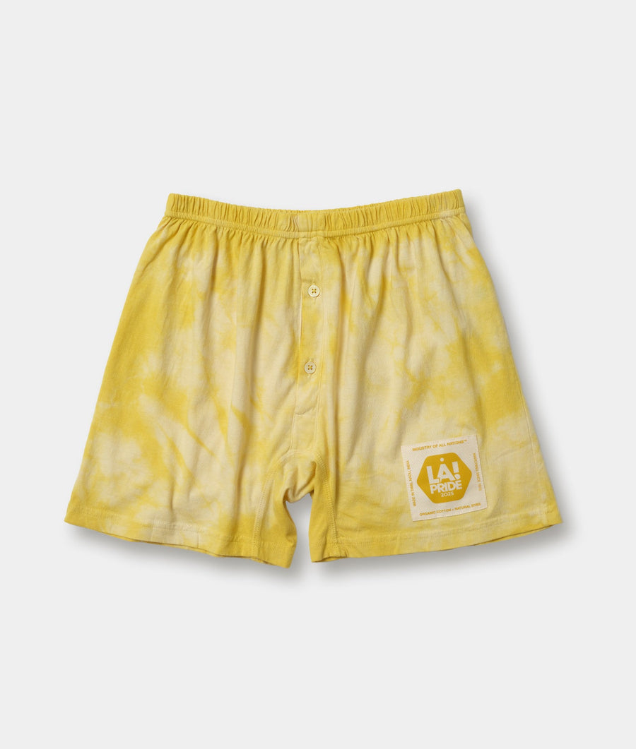 Bright yellow organic cotton boxer shorts with LA Pride logo displayed in flat lay - Industry of All Nations